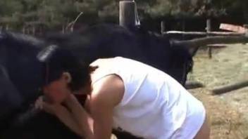 Brunette woman gives blowjob on a huge horse penis